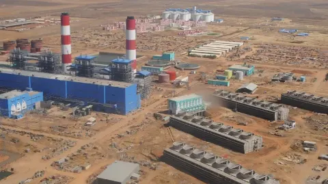 محطة كهرباء سودانية ومحولات ضغط عالٍ في أجواء ليلية قاتمة، مع أضواء تحذيرية ودخان في الخلفية، في مشهد صحفي واقعي يعكس المخاوف من استهداف منشآت الطاقة، دون إظهار أضرار محددة غير مؤكدة.
